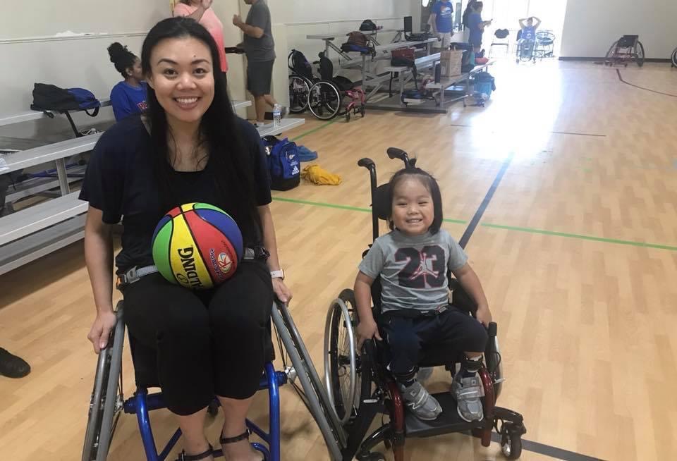Baby Ryle at his very first wheelchair basketball practice, smiling huge