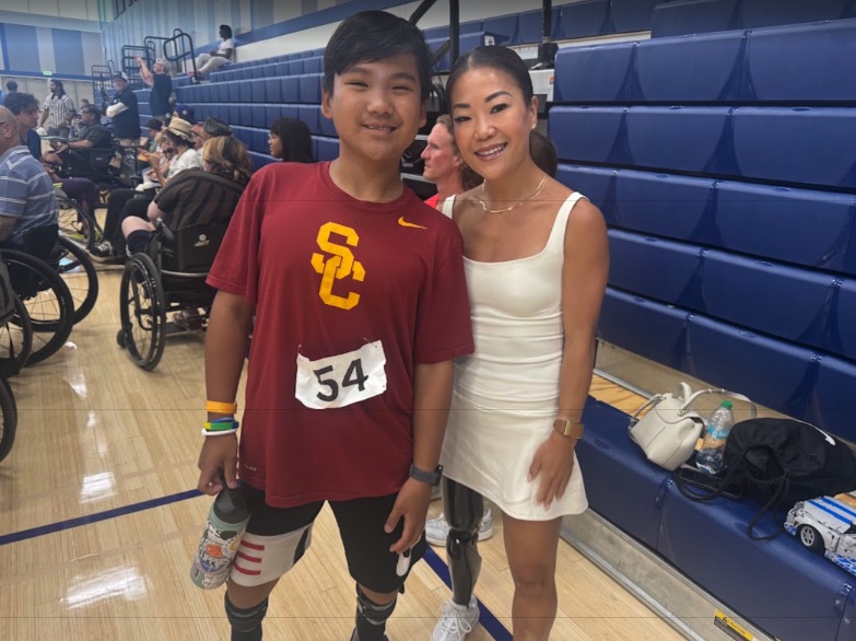 Ryle with an adaptive athlete in the gym between games