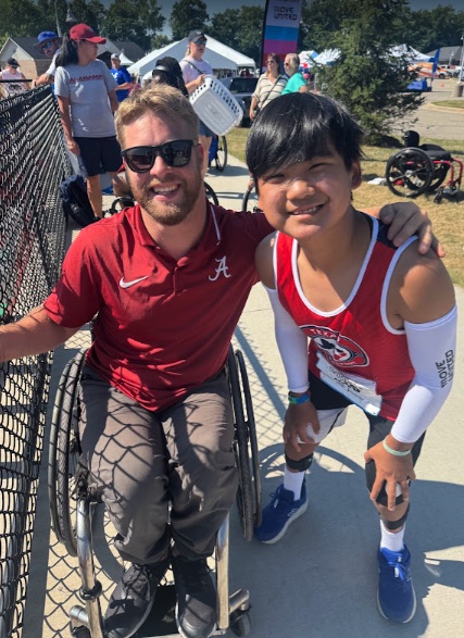 Ryle in his Nationals singlet with a veteran adaptive athlete at Move United Nationals
