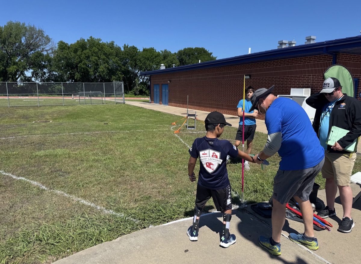 Ryle throwing javelin with coach