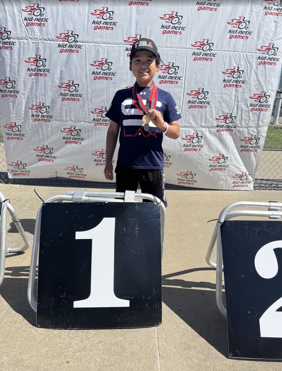 Ryle on the #1 podium at Kidnetic Games with medal