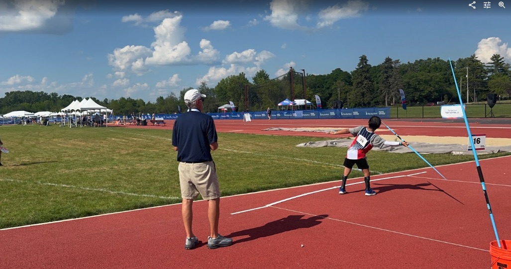 Ryle throwing javelin on the runway at Nationals