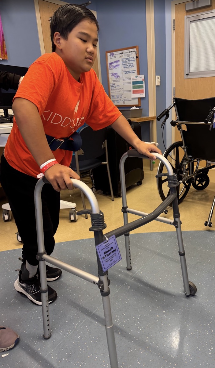 Ryle using walker independently in physical therapy