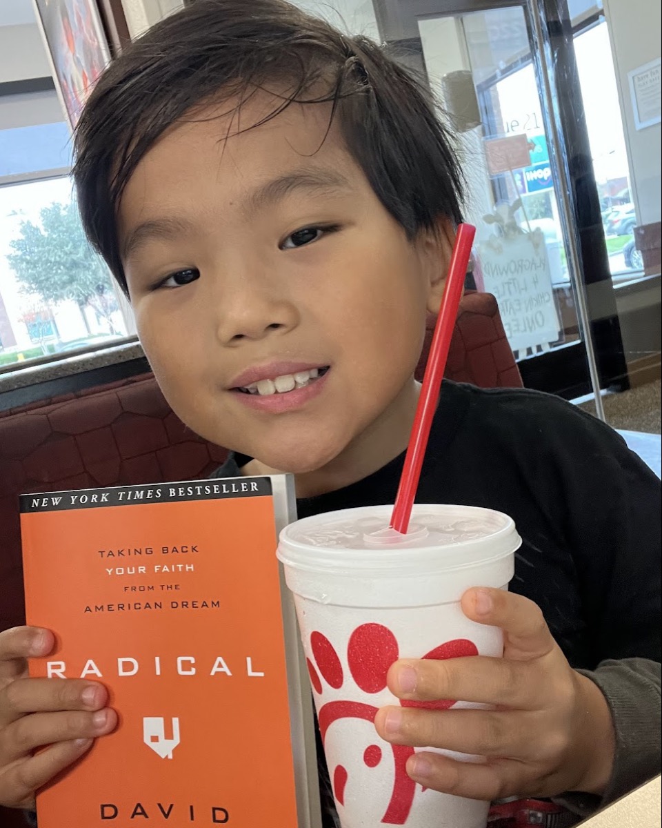 Ryle at Chick-fil-A reading Radical by David Platt